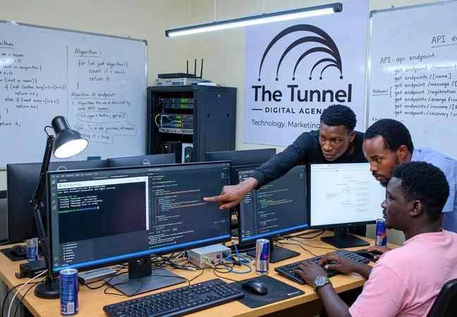 Developers at work in The Tunnel office in Kyebando, reviewing code across multiple monitors